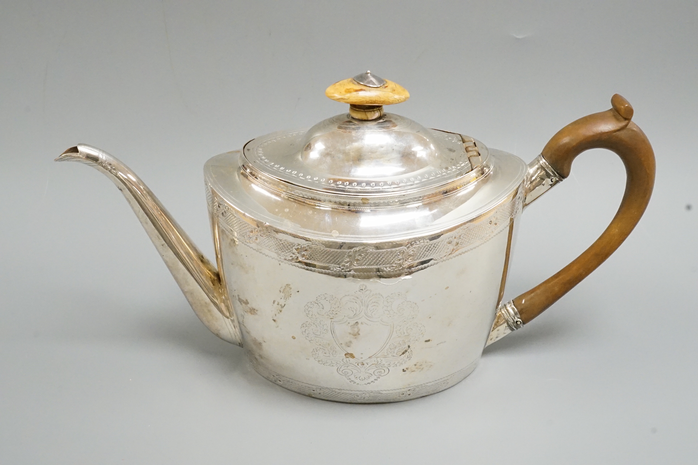 A George III chased oval silver teapot, by Thomas Wallis, London, 1798, gross weight 15.4oz.